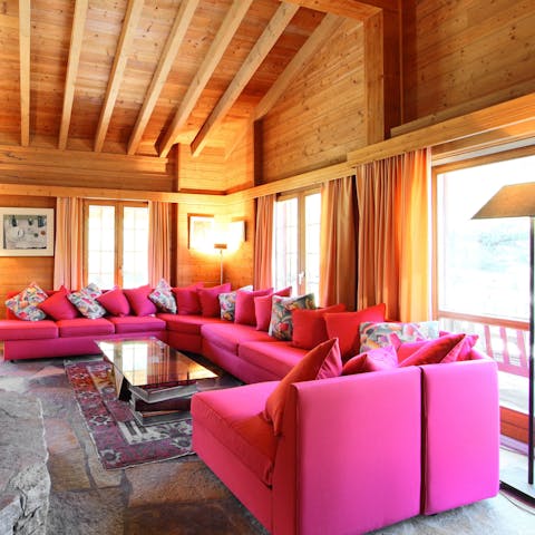 Get everyone snuggled up on the huge fuchsia sofa