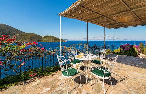 Enjoy an alfresco meal with views across the Ionian Sea to the mountains of northern Greece