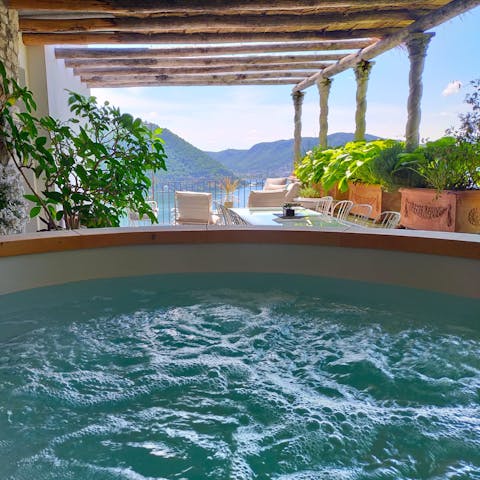 Relax in the hot tub while admiring views of the lake