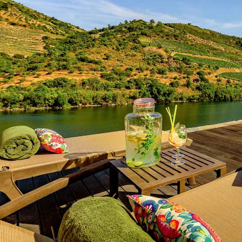 Soak up waterside views over the natural landscape with a cocktail in hand