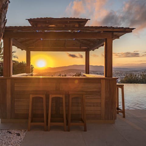 Get a sun-downer from the outdoor bar