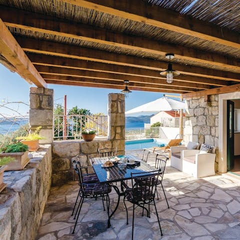Gather together for a shaded alfresco meal courtesy of the barbecue