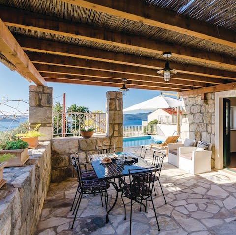 Gather together for a shaded alfresco meal courtesy of the barbecue