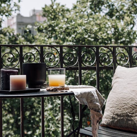 Relax and unwind on your private balcony overlooking the tree-lined boulevard