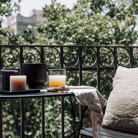 Relax and unwind on your private balcony overlooking the tree-lined boulevard