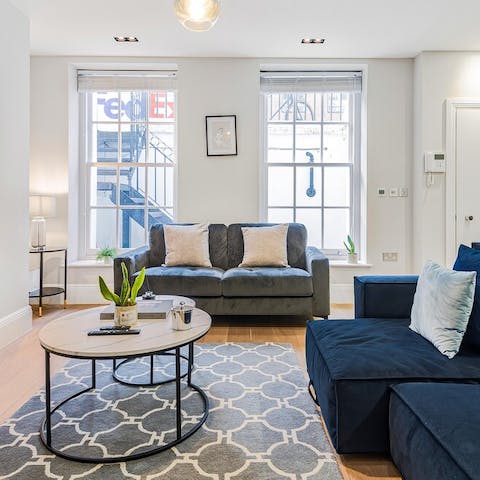 Settle in to the comfy sofa by big Georgian windows