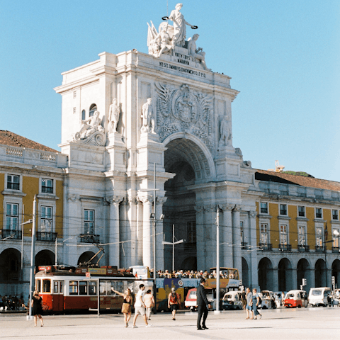 Enjoy some people-watching in the grand Praça do Comércio