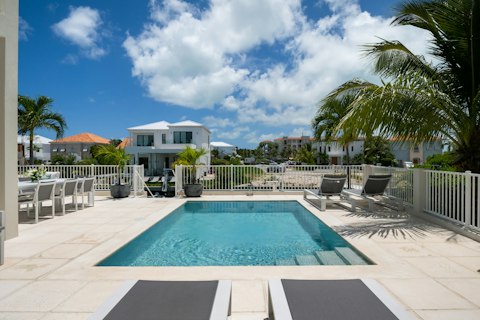 Stretch out beside your private pool overlooking the waterway