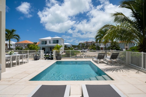 Stretch out beside your private pool overlooking the waterway