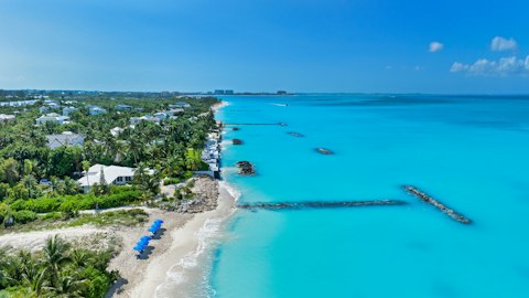 Sink your toes into the powdery sands of Leeward Beach, a twenty-minute walk away