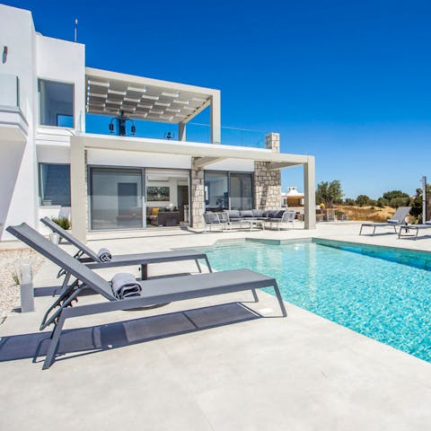 Laze by the pool on the the hot afternoons while sipping ouzo