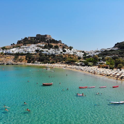 Spend leisurely days on the beach at Lindos village, 3.5km away