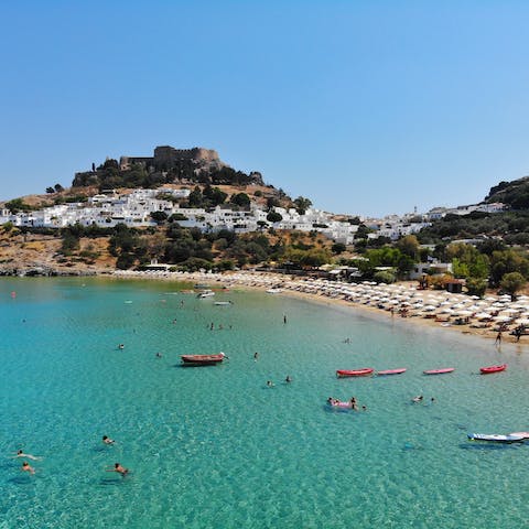 Spend leisurely days on the beach at Lindos village, 3.5km away