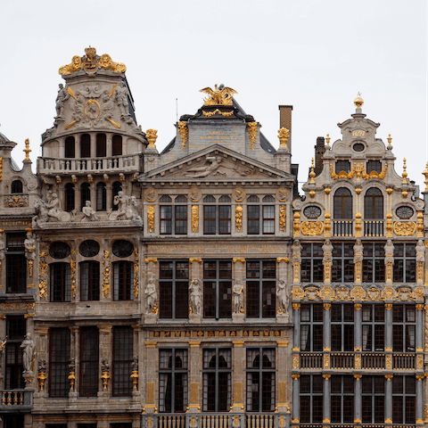 Stroll over to the Grand Place, a must-see market square known for stunning architecture