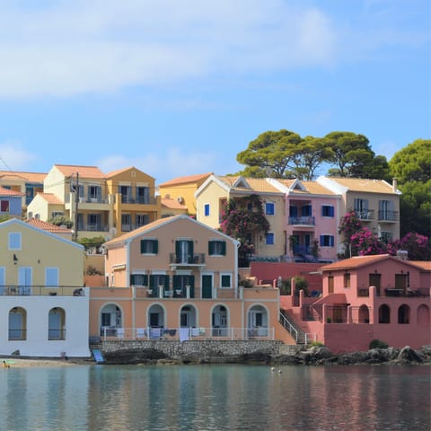 Visit the colourful homes on the coast of Sami, four minutes away by car