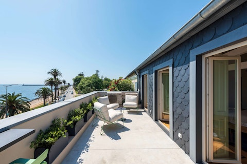 Sit out above the palm-lined seafront with Atlantic views