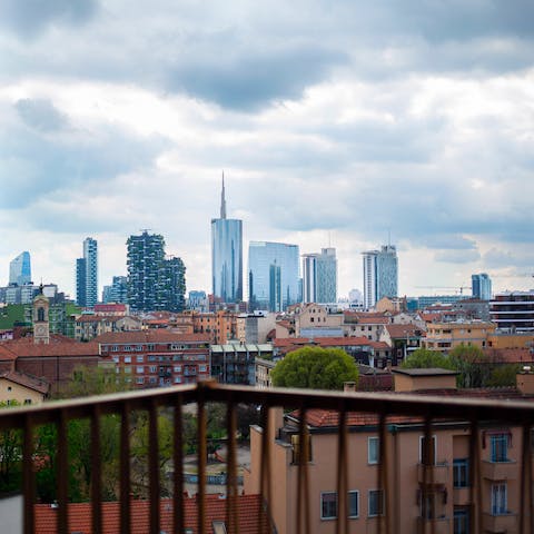 Admire the view over shambling rooftops to sleek skyscrapers from the balcony