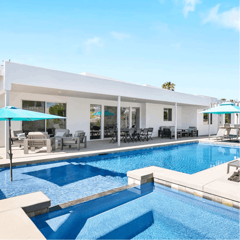 Lounge under the sun by the pool or in the waterfall spa