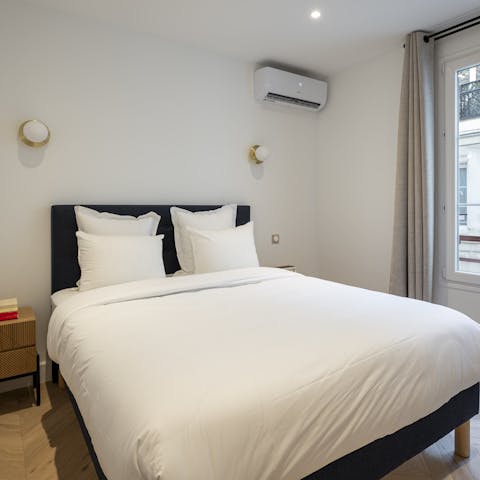 Sink into the sumptuous bed after a day of Paris sightseeing