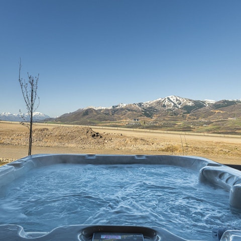 Sink into the hot tub and enjoy unobstructed mountain views