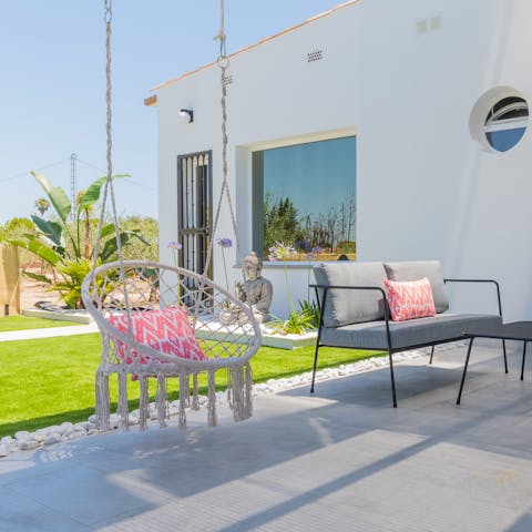 Turn pages of your holiday read from the swing seat