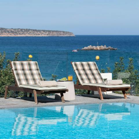 Soak up the sun on a poolside lounger with a sea view