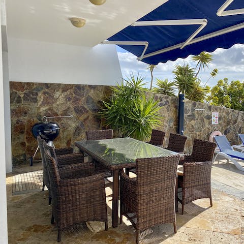 Sip on a glass of sangria at sunset out on the alfresco dining table