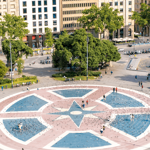 Stroll through bustling Plaça de Catalunya, twenty-four minutes away on foot