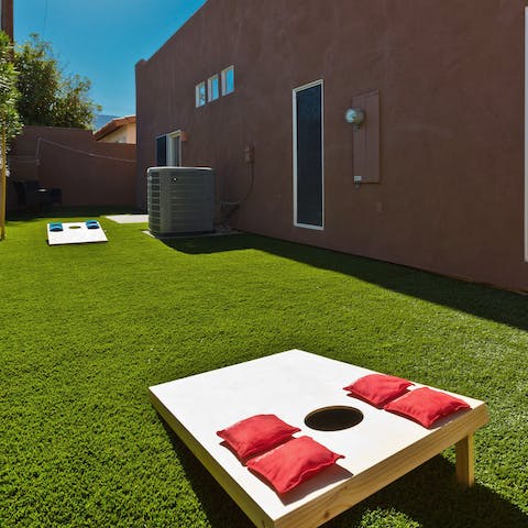 Play a few games of cornhole in the garden