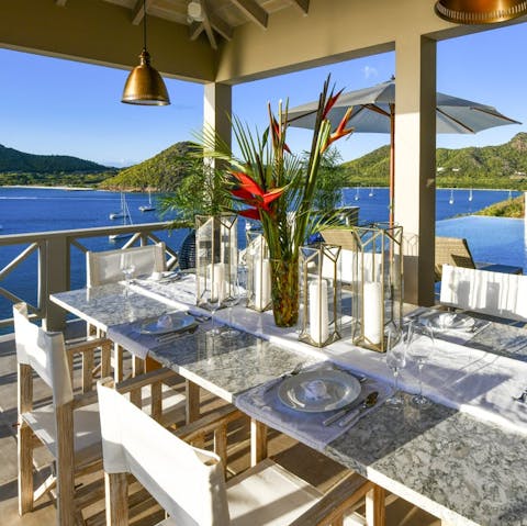 Drink in glittering Caribbean Sea views as you dine under the pergola
