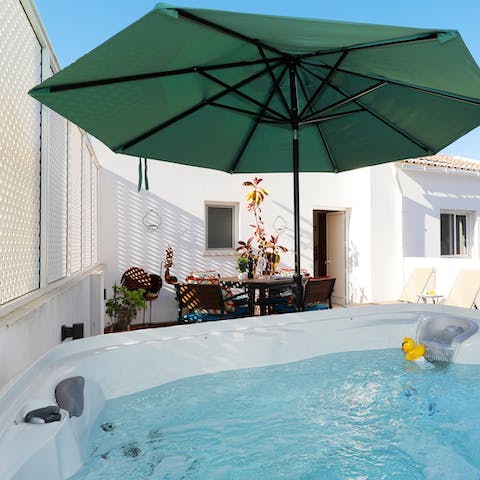 Enjoy a long soak in this hot tub after completing your remote work at the desk