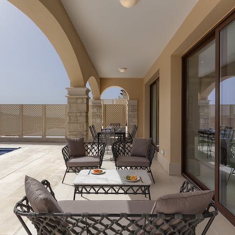 Find shade under the covered terrace while you sip on a cold glass of fizz