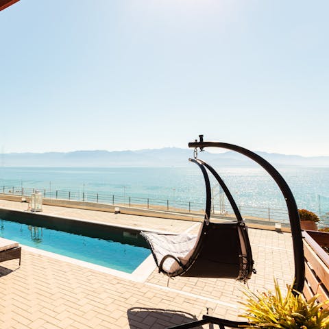 Enjoy stunning views over the ocean while you rest in your hanging lounge chair
