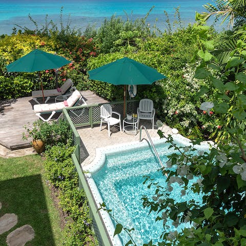Cool off with a dip in the private outdoor pool before relaxing on a sun lounger