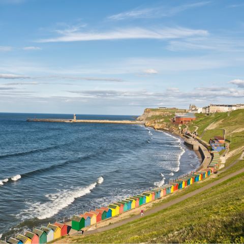 Cross the swing bridge over the River Esk and check out the beach huts at West Cliff Beach