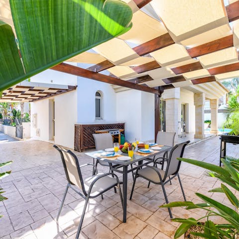 Sit down at the shaded dining table for an alfresco breakfast and fresh coffee