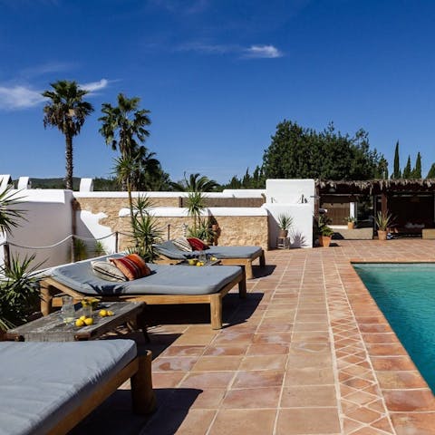 Soak up the sun on a lounger by the pool