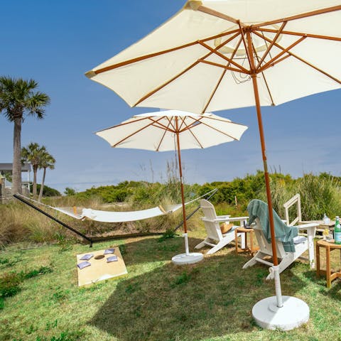 Relax in the lawned garden between days on the beach