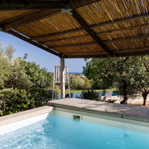 Hop in the jacuzzi, overlooking the pool and ocean view