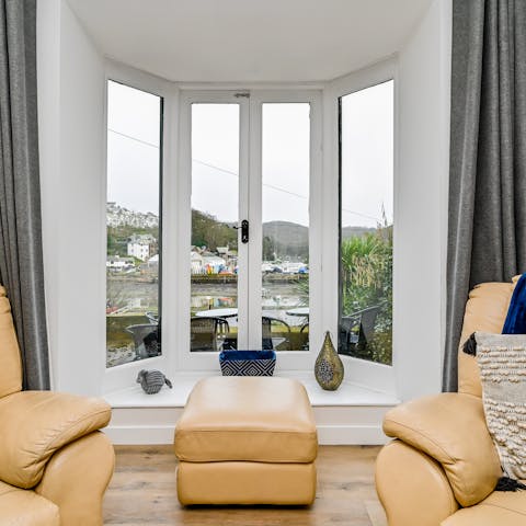 Watch the boats in the harbour from tall French windows