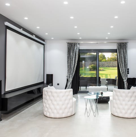 Gather around and watch a movie on the projector screen