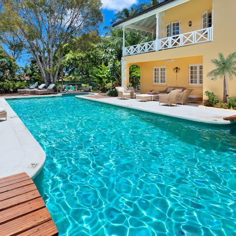 Glide gracefully through the azure waters of the swimming pool