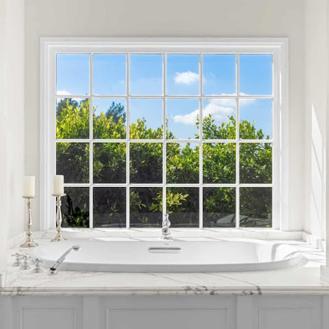 Light some candles and luxuriate in the elegant bathtub