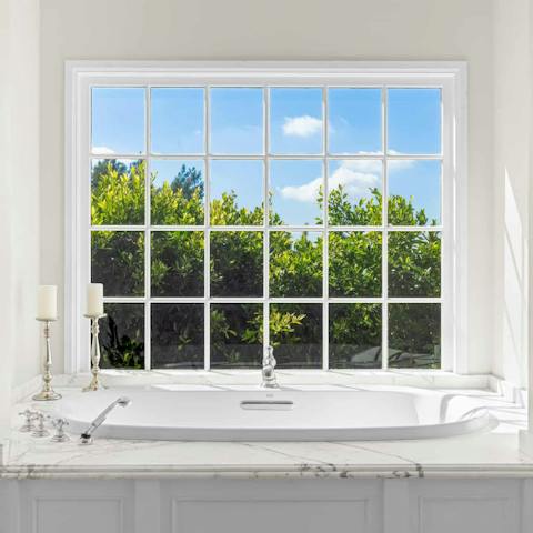 Light some candles and luxuriate in the elegant bathtub