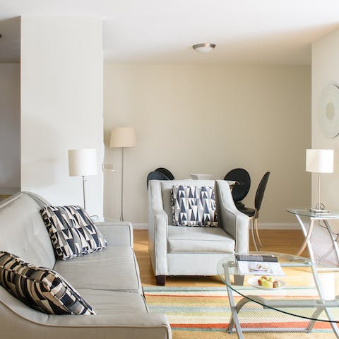 Flick through a magazine in the stylish living space with soft neutral tones