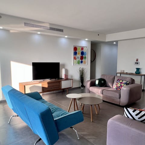 Sink into the plump sofas for a movie night after a day exploring Holon