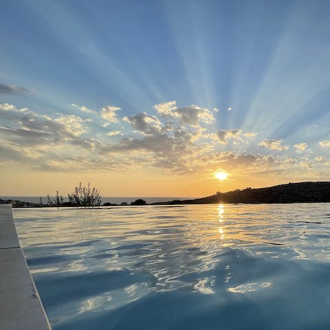 Take a sunset dip in the pool and admire the glimpse of the sea