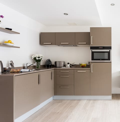 Cook a meal in the sleek coffee-coloured kitchen
