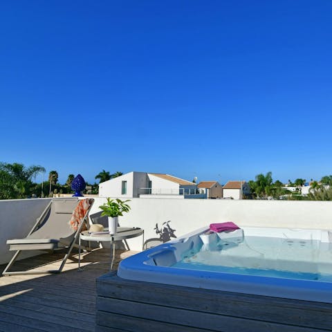 Relax on the sunny roof terrace, complete with hot tub