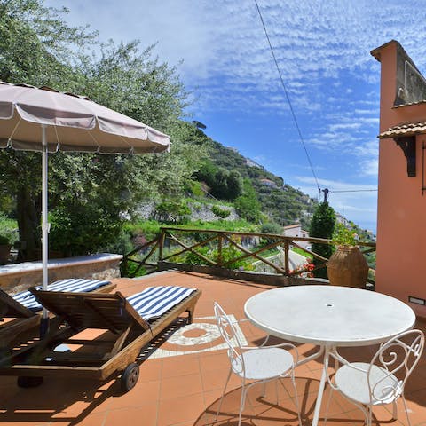 Take in gorgeous views of the Tyrrhenian Sea from the terrace while catching some rays